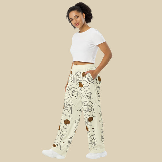 Woman wearing a white crop top and patterned pants on a beige background
