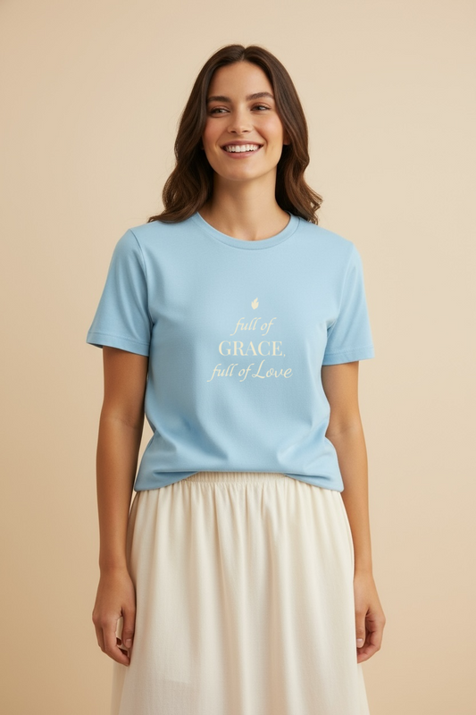 Woman wearing an ocean-blue faith-inspired t-shirt with the phrase Full of Grace, Full of Love, studio front view.