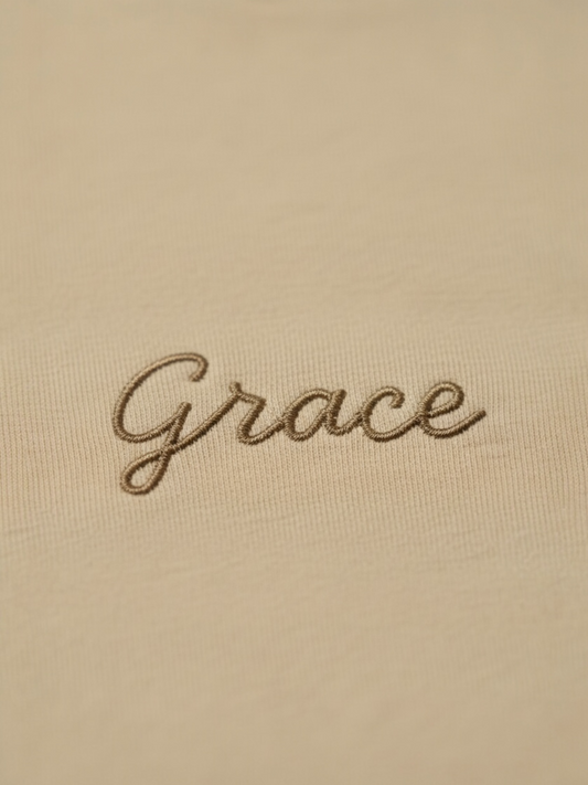 Embroidered word 'Grace' on a beige background